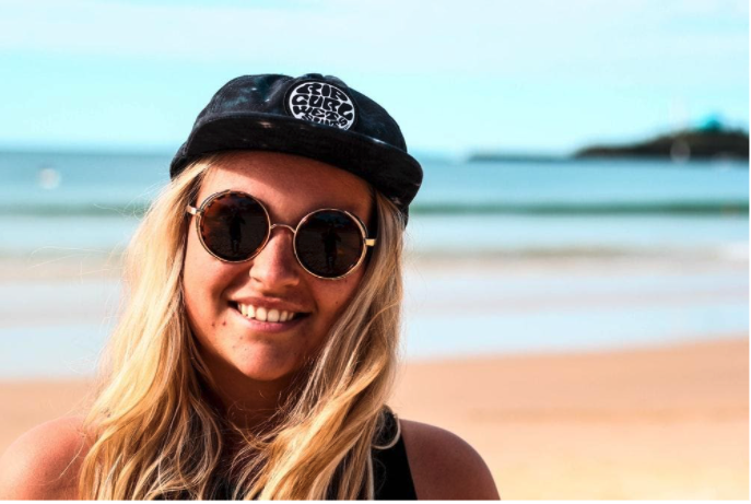 An example of an unprofessional LinkedIn profile picture - a female wearing sunglasses on a beach