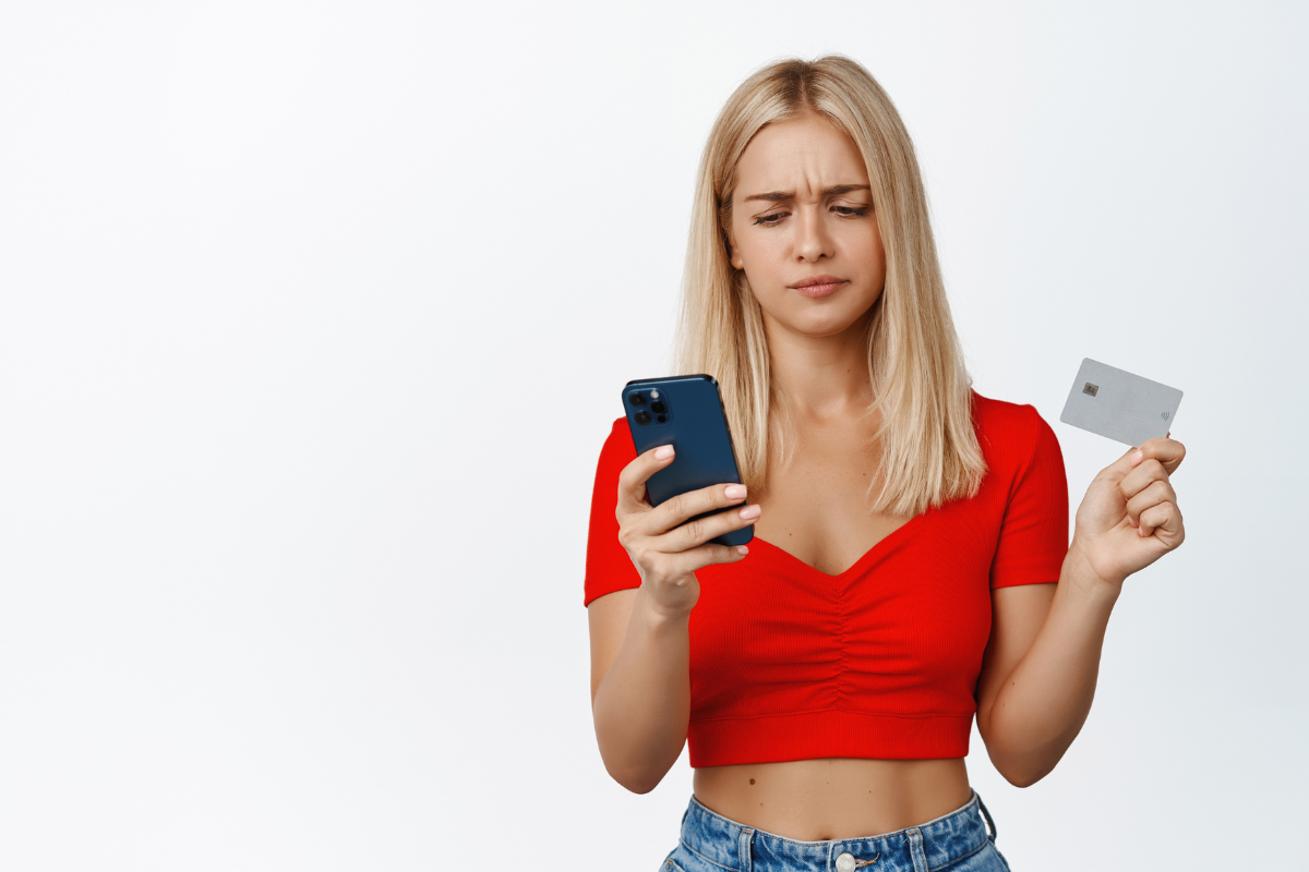 A girl holding a visit card and a mobile phone