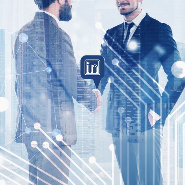 Business professionals shaking hands with LinkedIn logo and world map in background, symbolizing global networking and outreach on LinkedIn.
